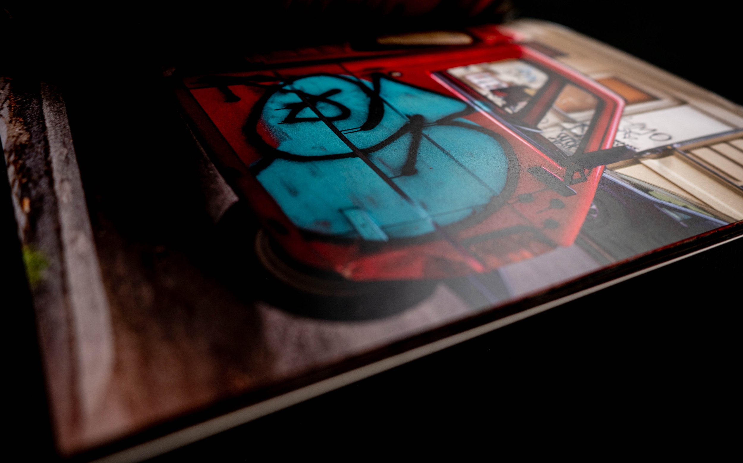 Open photography book showing image of red truck