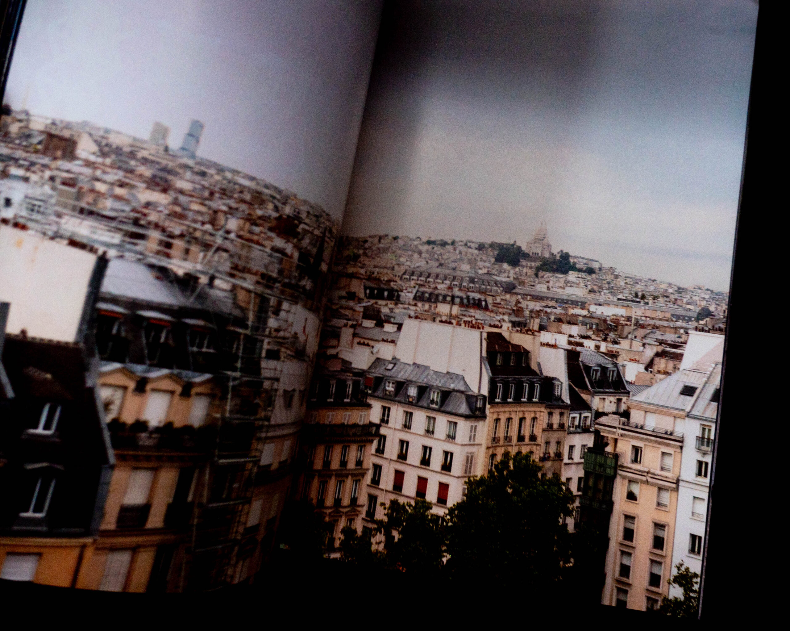 Open book showing photograph of Paris skyline